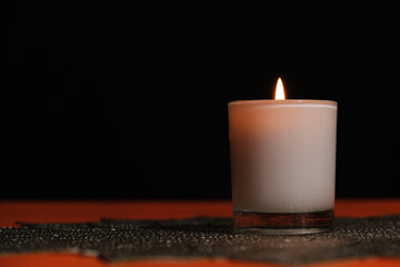 white candle light in the dark, grieving concept