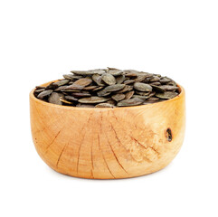 Pumpkin seeds in wooden plate isolated on a white background.