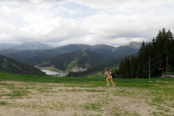 Tourist young girl child on the top of the Carpathian mountains Ukraine Bukovel. Vacation concept...