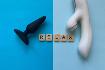 Anal toy and vibrator on blue background.  lettering RELAX. Assortment sex shop