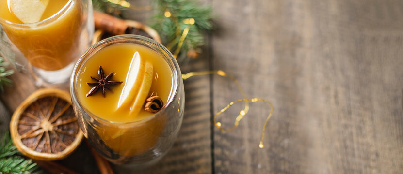 Hot apple cider with cinnamon sticks, apple and holiday christmas decoration. Top view. Banner image for design