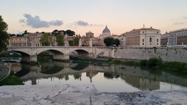 Tracking right steady cam view of Sant'Angelo castle and bridge above Tiber River at morning in Rome, Italy.