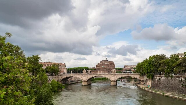 Time lapse video with moving clouds above medieval St. Angelo castle and Vittorio Emanuele II Bridge over Tiber river in Rome, Italy