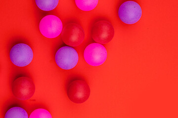 Abstract colored balls background. Multi-colored taw toy scattered on bright paper. Base for design nice backdrop, wallpaper, poster. Noisy surface texture