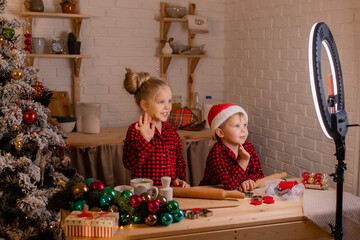 two small children cook a pie for Christmas and shoot a cooking blog. children bloggers