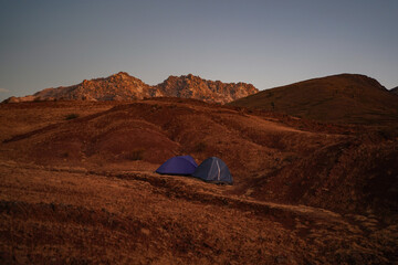 Wild camping at dusk with two tents in a landscape around Maragua crater, Sucre, Bolivia.