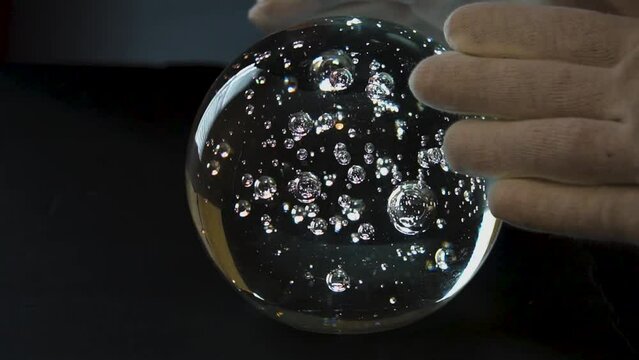 Magic crystal ball reveals with hands manipulating the psychic field