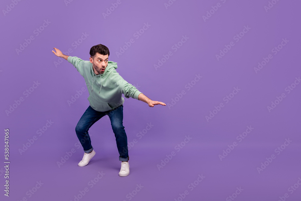 Wall mural Full length photo of youngster excited man wear khaki sweatshirt pouted lips nervous unexpected look empty space advert isolated on violet color background