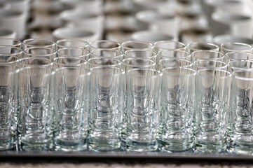 abstract background of many rows of glass glasses and cups of coffee or tea, selective focus