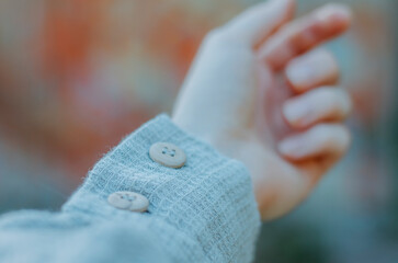 Wooden buttons on waffle linen shirt close up