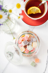 Turkish Delight. view of the tol with a cup of tea and Turkish delight sweets on a plate. A traditional oriental treat is sweetness.