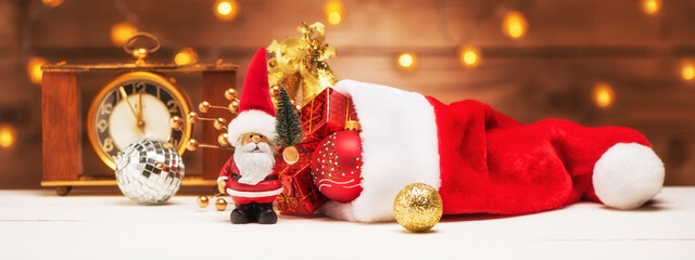 Christmas holidays banner with Santa Claus and hat with gifts. Merry christmas and happy new year concept greeting card