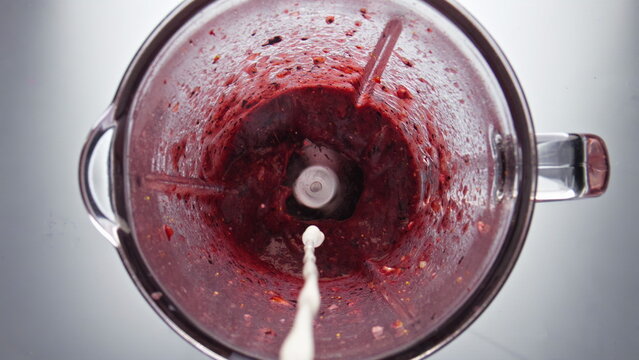 Closeup Milk Pouring Blender With Berry Blend In Super Slow Motion Top View.