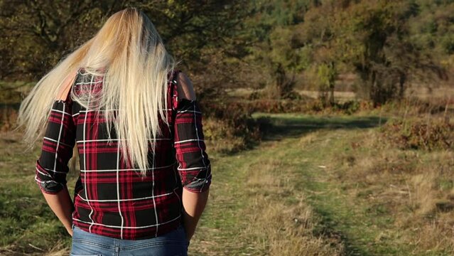woman walking in autumn fields
