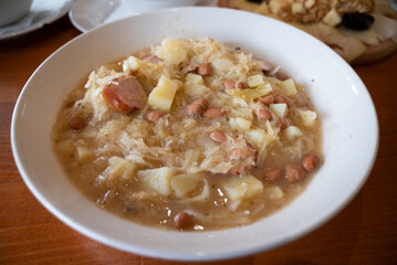 Jota,  a Sauerkraut and beans stew, containing sour cabbage, potatoes, white beans and sausages  - obrazy, fototapety, plakaty