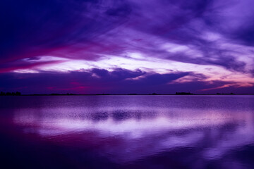 Fototapeta na wymiar blue hour in a lagoon. Clouds cover the sky.