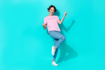 Full size photo of nice cute girl pink t-shirt jeans white sneakers scream yeah raise fists up good...