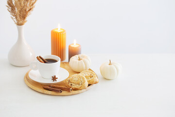 white cup of coffee with cozy decor on white table