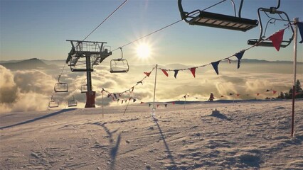 Magic sunny winter morning in mountains ski resort with empty chairlift starting in new day
