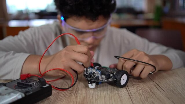 young asian boy work on technology experiment project at school,technology concept,	