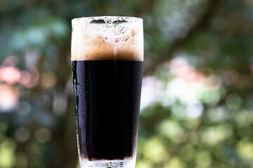 Closeup of glass with stout beer.