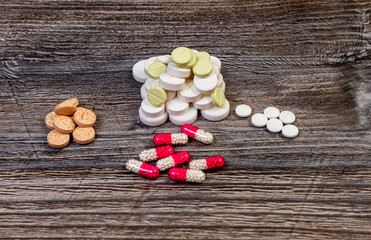 Medical colorful pills on isolated on wooden  background