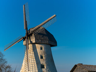 Traditional dutch windmill with blue sky on background. Old european style.