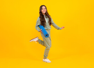 Fototapeta na wymiar Teen girl 12, 13, 14 years old in sport suit. Fashion child in sportswear sportive clothing. Sportive fashionable outfit. Studio shot on yellow background.