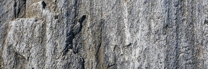 Natural rock background. Gray grunge banner. Abstract stone background. The texture of the stone wall close up. Light gray rock backdrop. Long Banner.