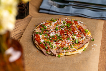 pizza with ham on the table in the restaurant