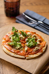 pizza with salmon on the table in the restaurant