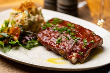grilled pork ribs in sauce in a restaurant