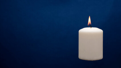 Wax candle with a blue dark back flame