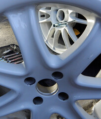 Mounting of new wheel rim through damaged dismantled wheel disk vertical stock photo
