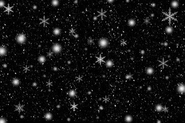 黒い背景に雪と雪の結晶