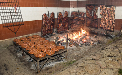 Barbecue, sausage and cow ribs, traditional argentine cuisine, Patagonia, Argentina.