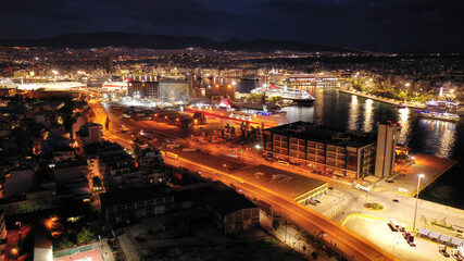 Fototapeta na wymiar Aerial drone night shot of passenger ferry arriving to famous passenger port of Piraeus one of the largest in Europe, Attica, Greece