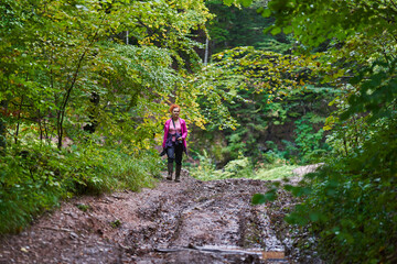 Nature photographer lady hiking in the forest
