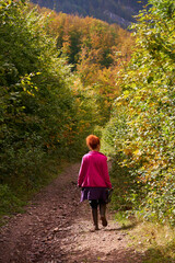 Nature photographer lady hiking in the forest