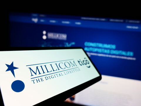 Stuttgart, Germany - 10-03-2022: Mobile phone with logo of company Millicom International Cellular S.A. on screen in front of business website. Focus on left of phone display.