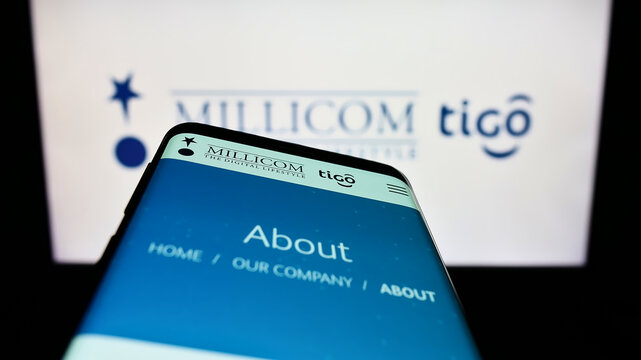 Stuttgart, Germany - 10-03-2022: Smartphone with website of company Millicom International Cellular S.A. on screen in front of business logo. Focus on top-left of phone display.