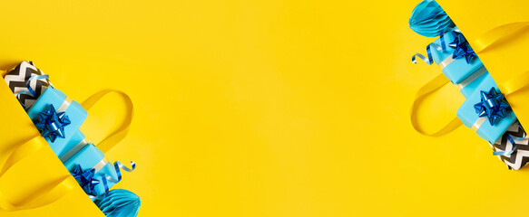 Banner with gift boxes in shopping bag. Holidays shopping concept flat lay, top view. Copy space