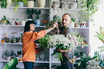 Woman and man work in florist shop.