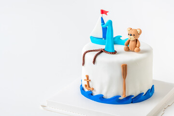 boat and doll bear fondant on vanilla cake on white background,