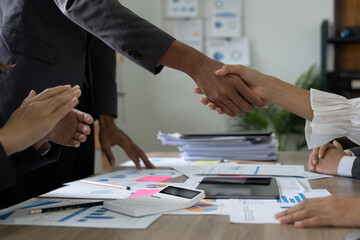 Group business people handshake at meeting table in office together with confident shot from top...