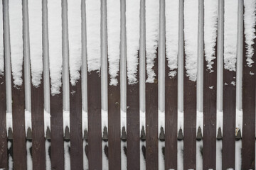 Wooden fence in hoarfrost. Severe frost and a lot of snow in winter. Close up. High quality photo
