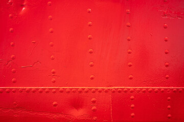 texture background with red metal wall with rivets