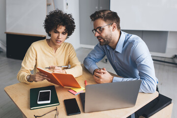 Millenial business man and woman working in office