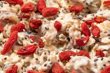 Museli with yogurt, goji berries and chia seeds close up detail