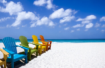 Colorful wooden chairs on white sand beach